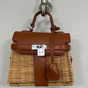Unbranded wicker top handle bag with leather shoulder straps.
